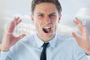 Composite image of angry businessman shouting