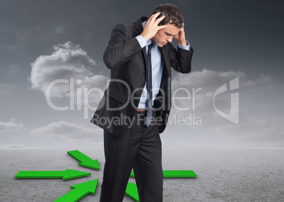 Composite image of stressed businessman with hands on head