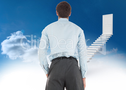 Composite image of businessman standing with hand in pocket