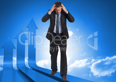 Composite image of stressed businessman with hands on head