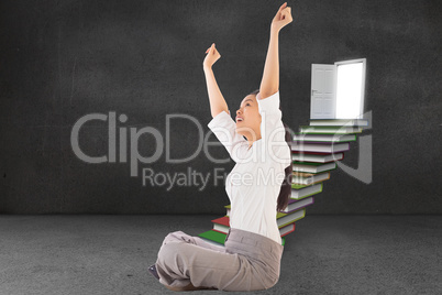 Composite image of businesswoman sitting cross legged cheering