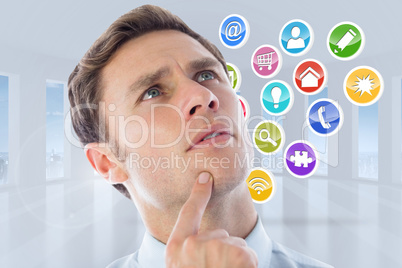 Composite image of thinking businessman with finger on chin