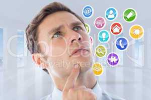 Composite image of thinking businessman with finger on chin