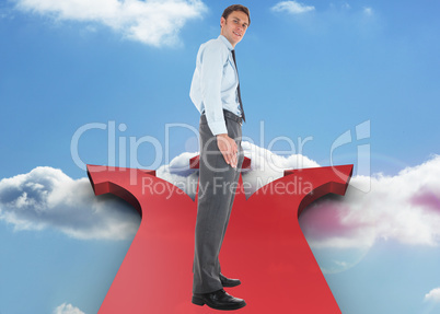 Composite image of happy businessman standing with hands in pock