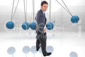 Composite image of cheerful businessman standing with hands on h