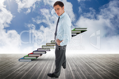 Composite image of thinking businessman scratching head