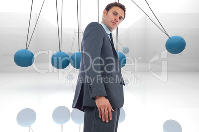 Composite image of stern businessman standing