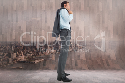 Composite image of serious businessman holding his jacket