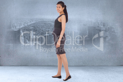 Composite image of asian businesswoman walking