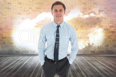 Composite image of happy businessman standing with hands in pock