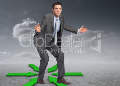 Composite image of businessman standing with arms out