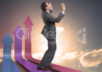 Composite image of businessman posing with arms raised