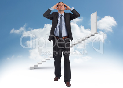 Composite image of stressed businessman with hands on head