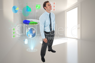 Composite image of happy businessman standing with hand in pocke