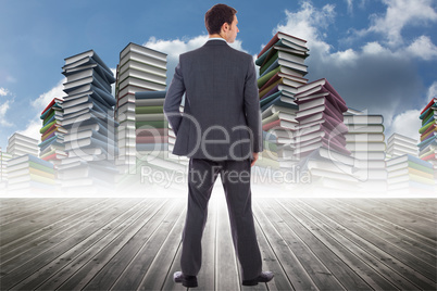 Composite image of serious businessman with hand in pocket