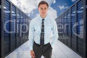 Composite image of serious businessman with hand in pocket