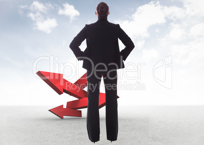 Composite image of businesswoman with hands on hips