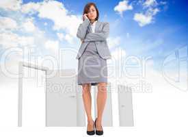 Composite image of worried businesswoman