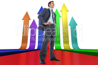 Composite image of happy businessman with hands on hips