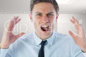 Composite image of angry businessman shouting