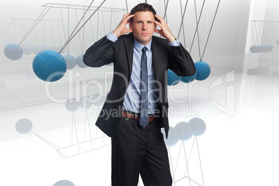 Composite image of stressed businessman with hands on head