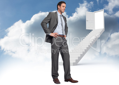 Composite image of smiling businessman with hands on hips