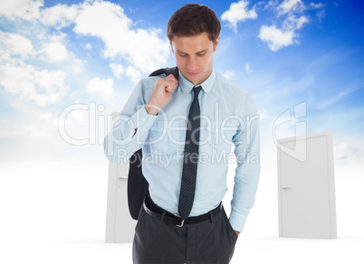 Composite image of serious businessman holding his jacket