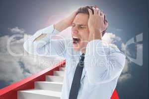 Composite image of stressed businessman with hands on head