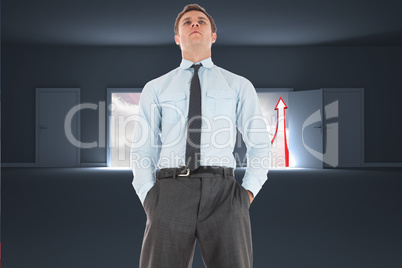 Composite image of serious businessman standing with hands in po