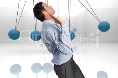 Composite image of businessman standing with arms pushing up