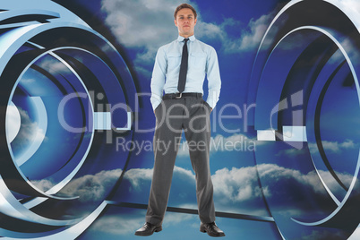 Composite image of serious businessman standing with hands in po