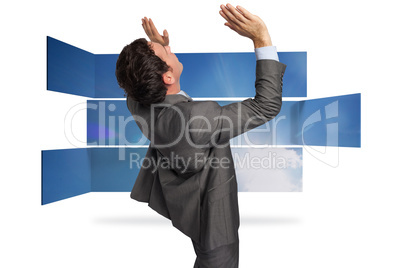 Composite image of businessman standing with arms pressing up