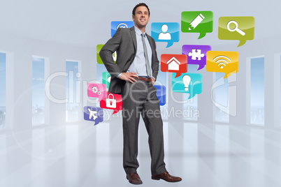 Composite image of smiling businessman with hands on hips