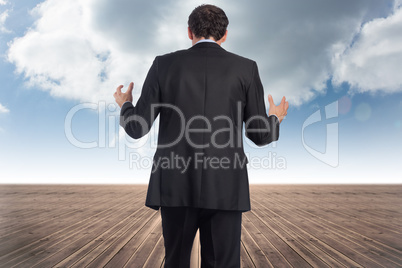 Composite image of stressed businessman gesturing