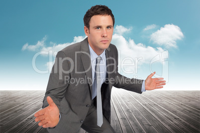 Composite image of businessman posing with hands out