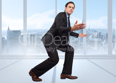 Composite image of businessman posing with arms outstretched