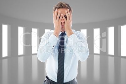 Composite image of businessman with a headache