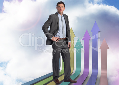 Composite image of serious businessman with hand on hip