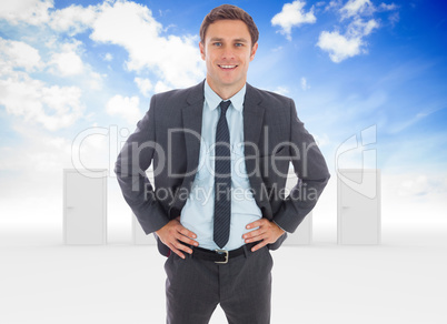 Composite image of cheerful businessman standing with hands on h