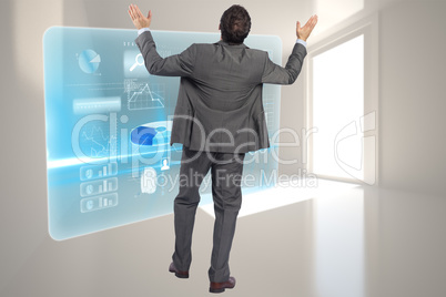 Composite image of businessman posing with arms raised