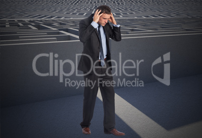 Composite image of stressed businessman with hands on head