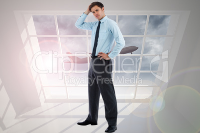 Composite image of thoughtful businessman with hand on head