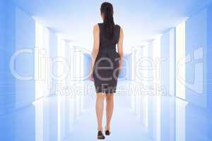 Composite image of businesswoman walking