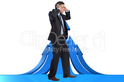 Composite image of stressed businessman with hands on head