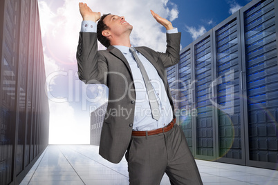 Composite image of businessman standing with arms pressing up