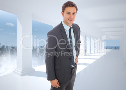 Composite image of cheerful businessman standing with hand on hi