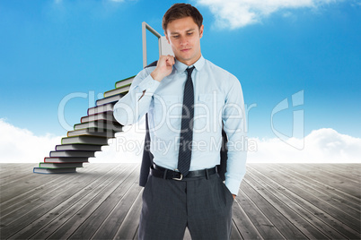 Composite image of serious businessman holding his jacket