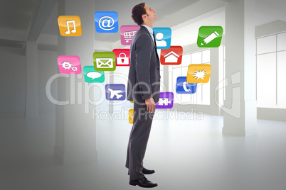 Composite image of happy businessman with hand in pocket Composite image of happy businessman with hand in pocket