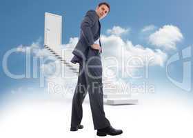 Composite image of serious businessman with hands on hips