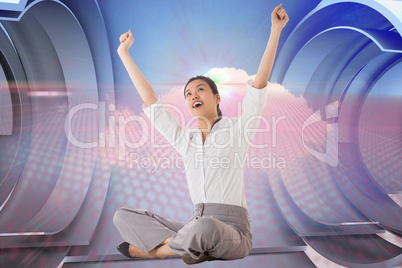 Composite image of businesswoman sitting cross legged cheering